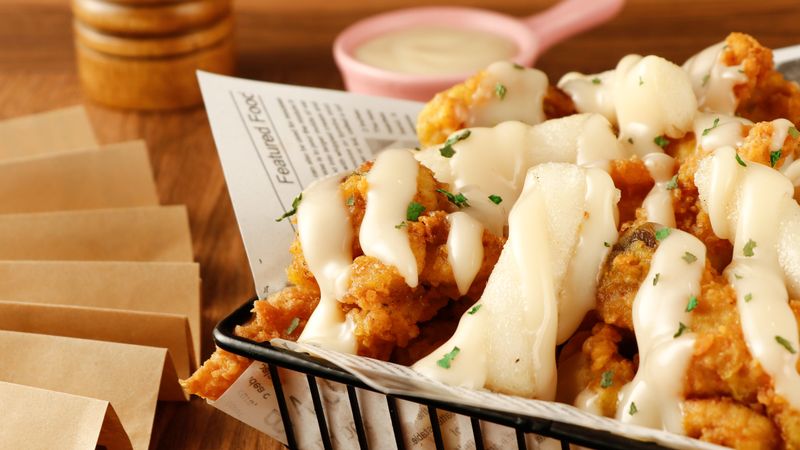 Spicy hot wings with chili garnish showing heat levels